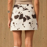 WILD WILD WEST COW PRINT MINI SKIRT